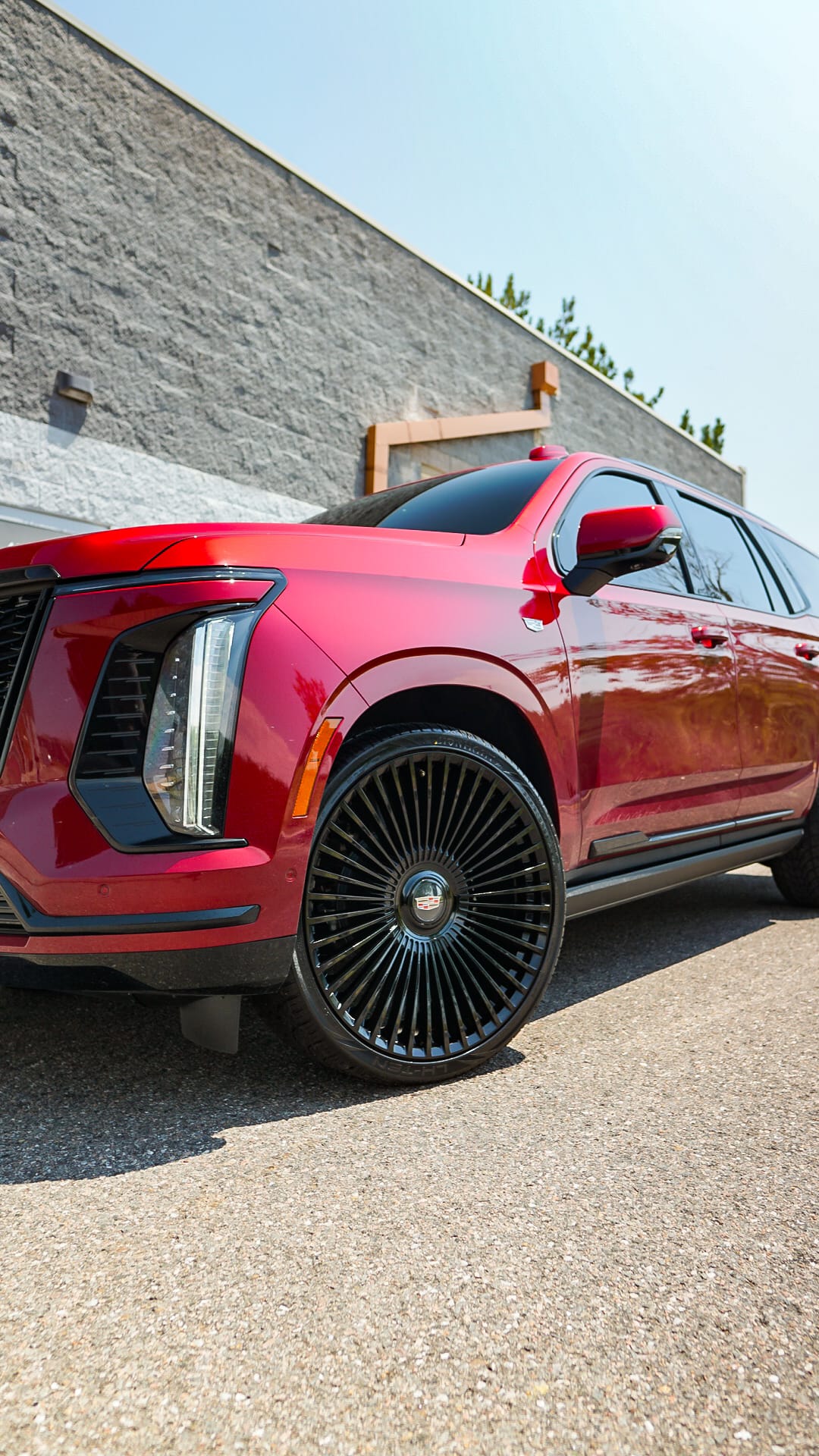 Candy red Cadillac Escalade on black turbine-spoke wheels