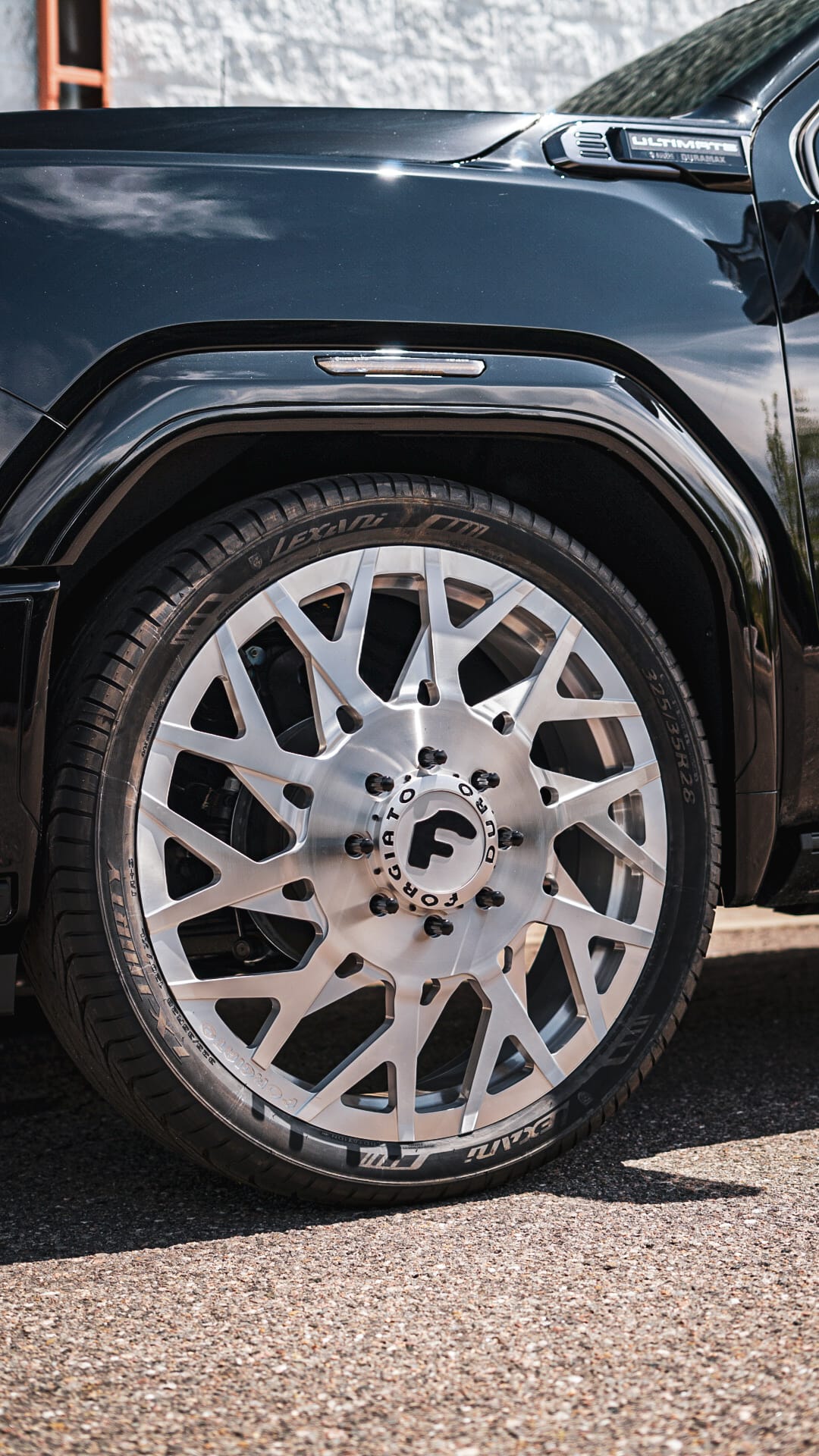Black GMC Denali dually on brushed Forgiato Duro wheels — front