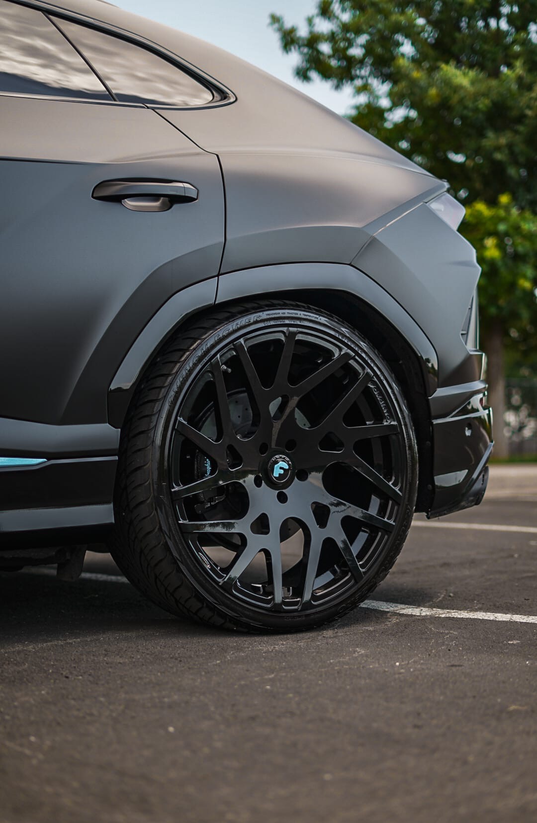 Matte black Lamborghini Urus rear wheel detail with Forgiato mesh