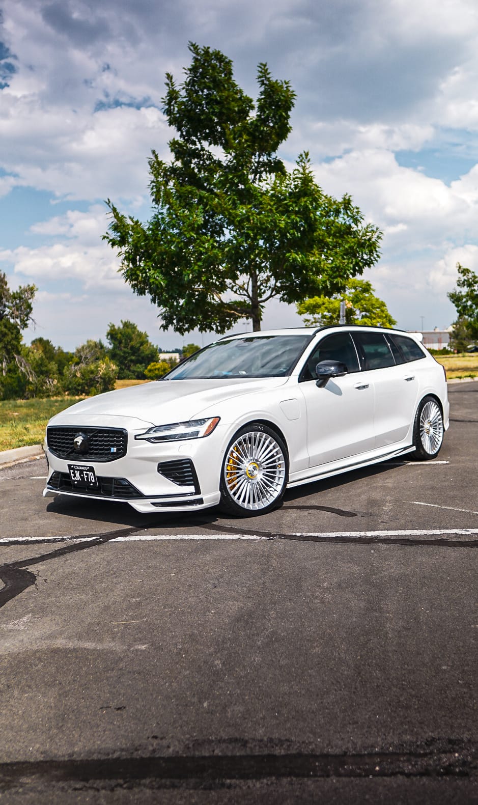 White Volvo V60 wagon on polished multi-spoke wheels
