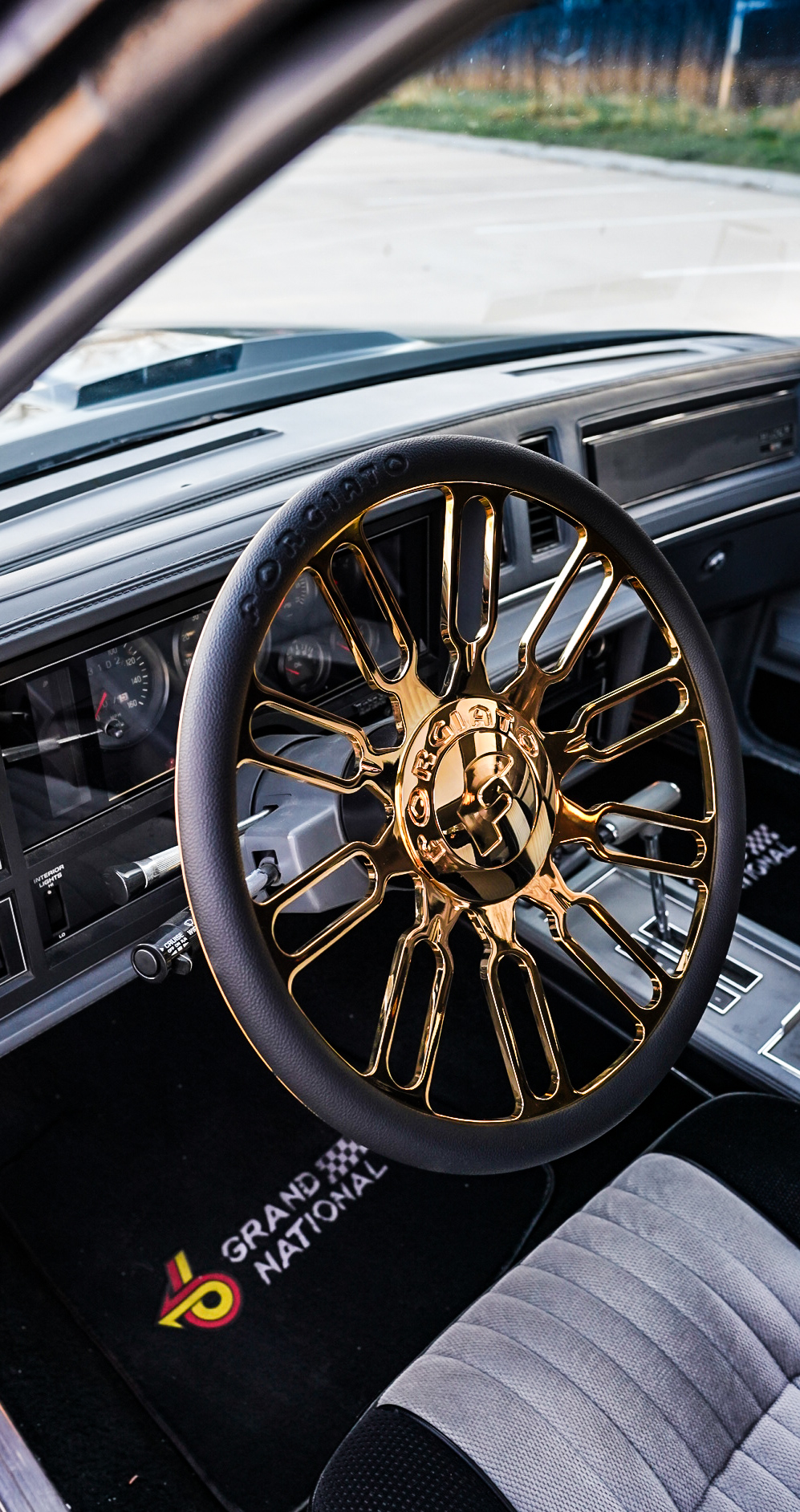 Gold Forgiato steering wheel and Grand National floor mats inside Buick GN
