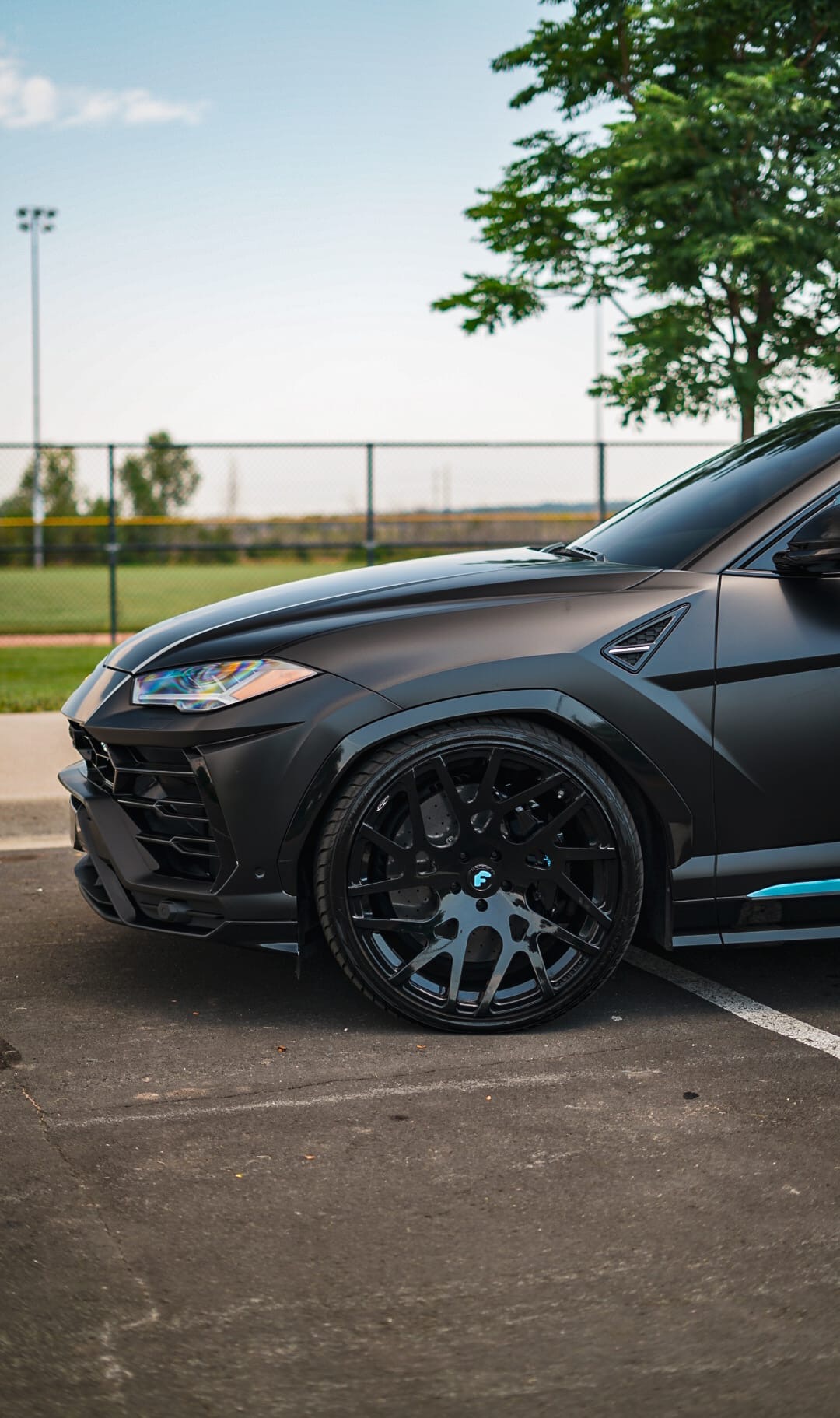Matte black Lamborghini Urus on Forgiato wheels — front three-quarter